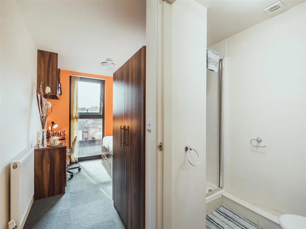 Desk bed wardrobe and shower cubicle bedroom bathroom at Lomax Halls in Stoke-On-Trent Student Accommodation