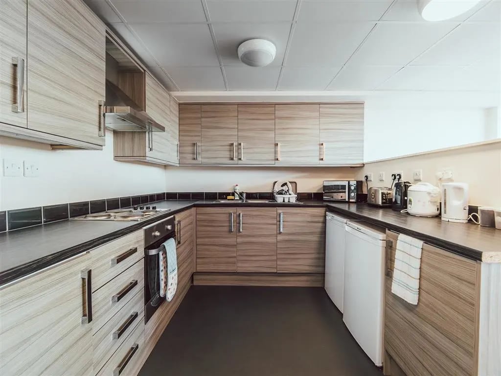 Modern student kitchen with appliances cabinets and counter. Kitchen at Lomax Halls in Stoke-On-Trent Student Accommodation