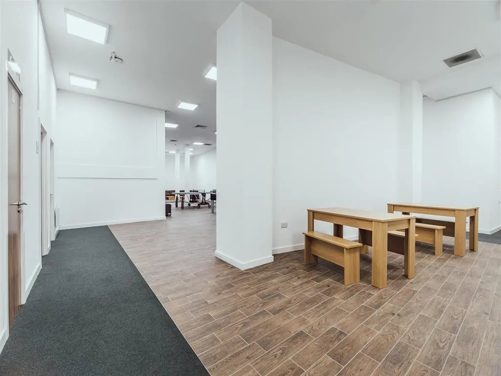Wooden tables and benches communal area at Lomax Halls in Stoke-On-Trent Student Accommodation