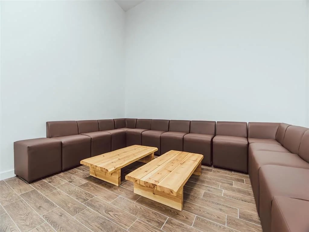 Modular brown sofa and two wooden coffee tables living room at Lomax Halls in Stoke-On-Trent Student Accommodation
