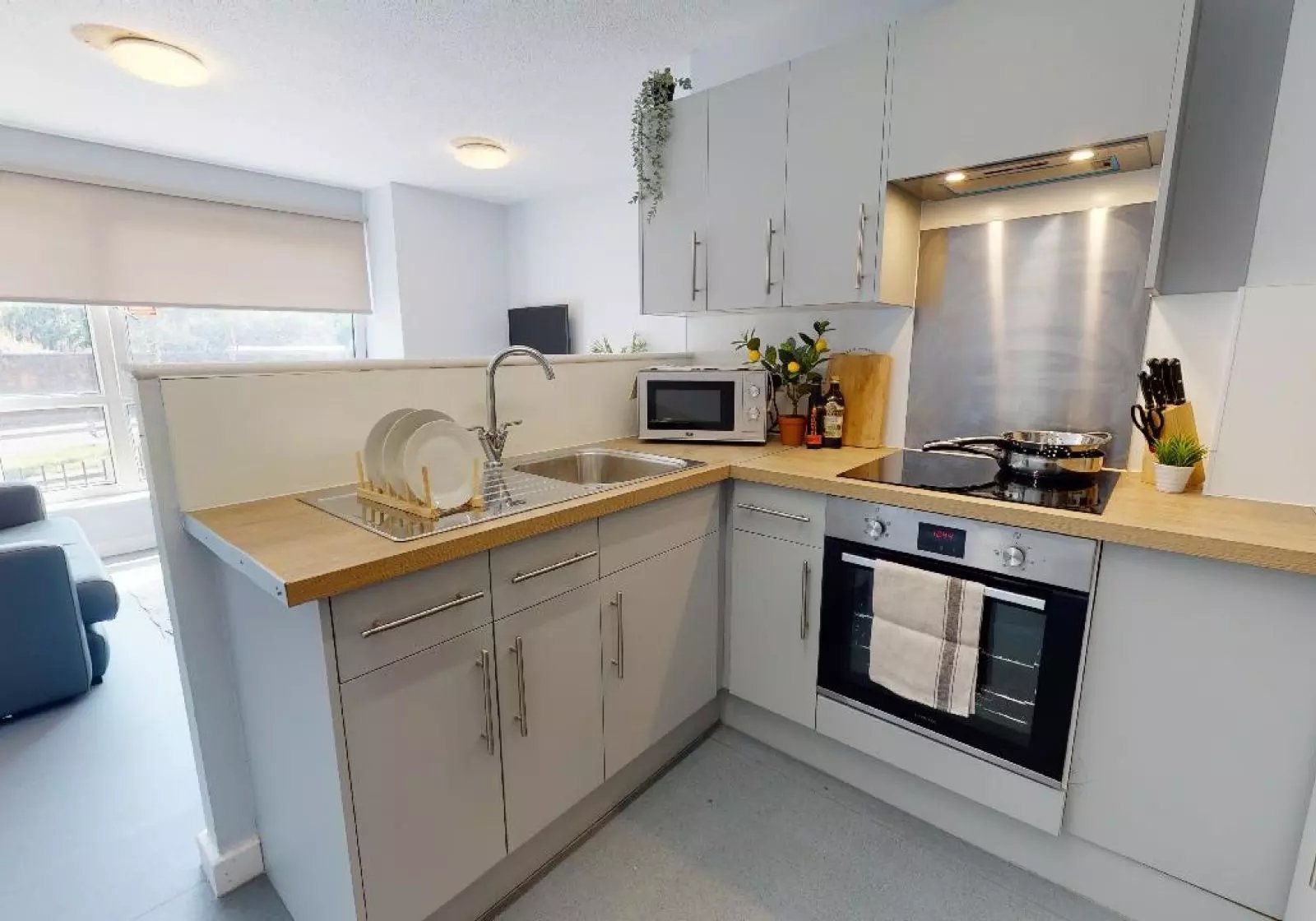 Kitchen with sink microwave oven and cabinets kitchen at iQ Fiveways House in Wolverhampton Student Accommodation
