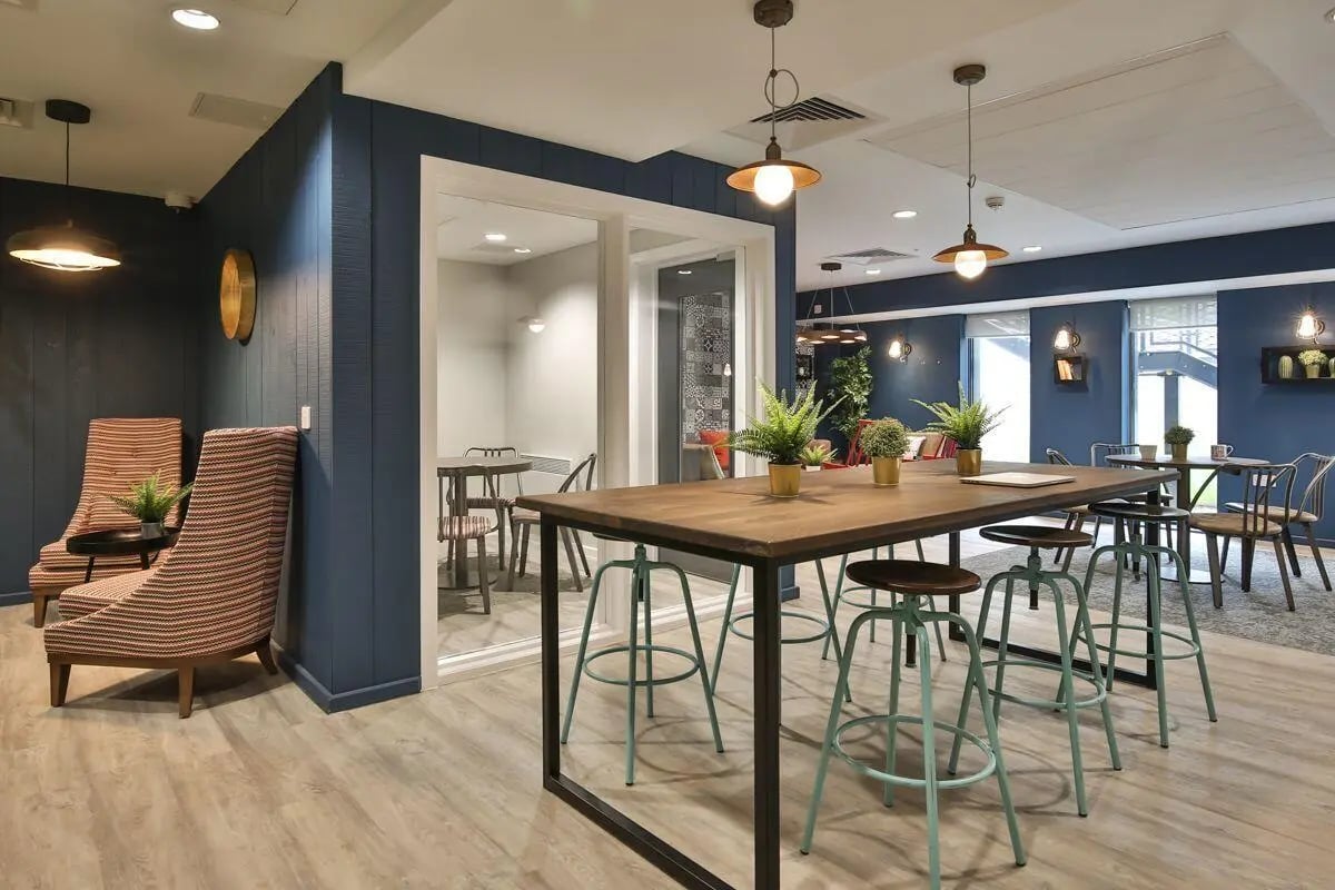 Communal table with stools and seating area living room at Princess Road East in Leicester Student Accommodation
