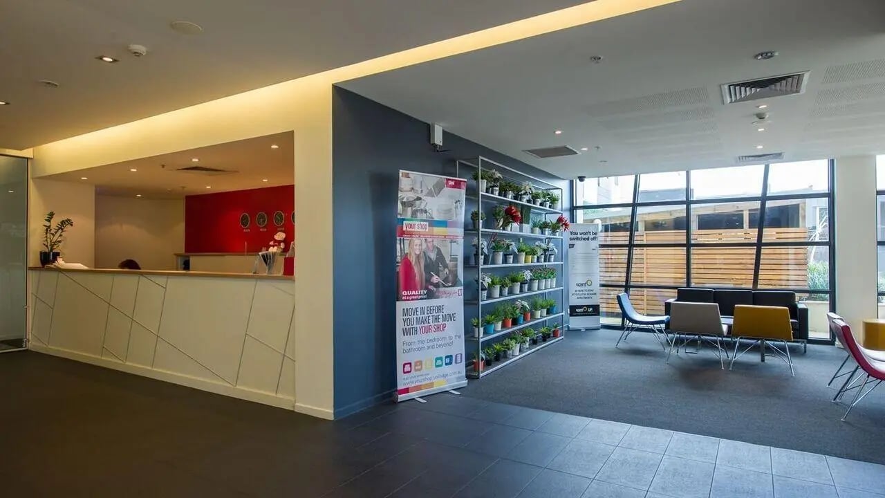 Reception area with seating and plants communal area at Student Living - 800 Swanston in Melbourne Student Accommodation