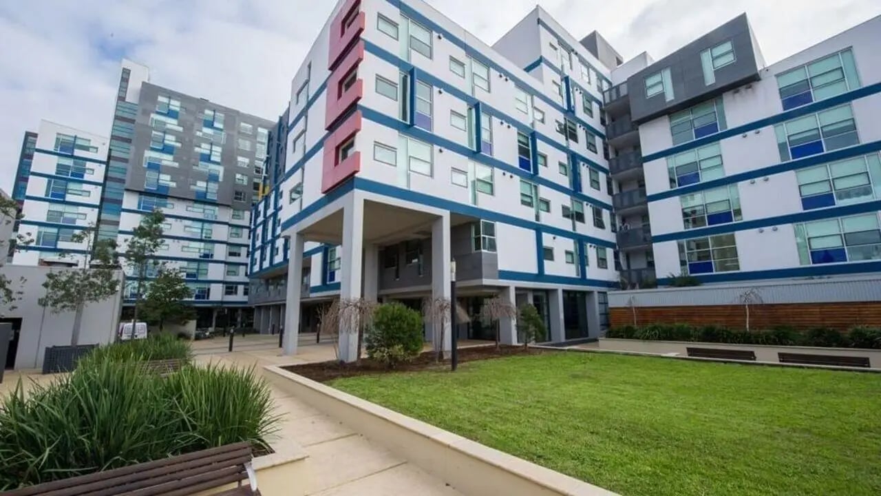 Modern apartment buildings with balconies and courtyard exterior at Student Living - 800 Swanston in Melbourne Student Accommodation