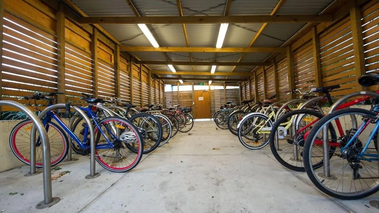 Many bikes in a wooden covered bike rack parking exterior at Student Living - 800 Swanston in Melbourne Student Accommodation