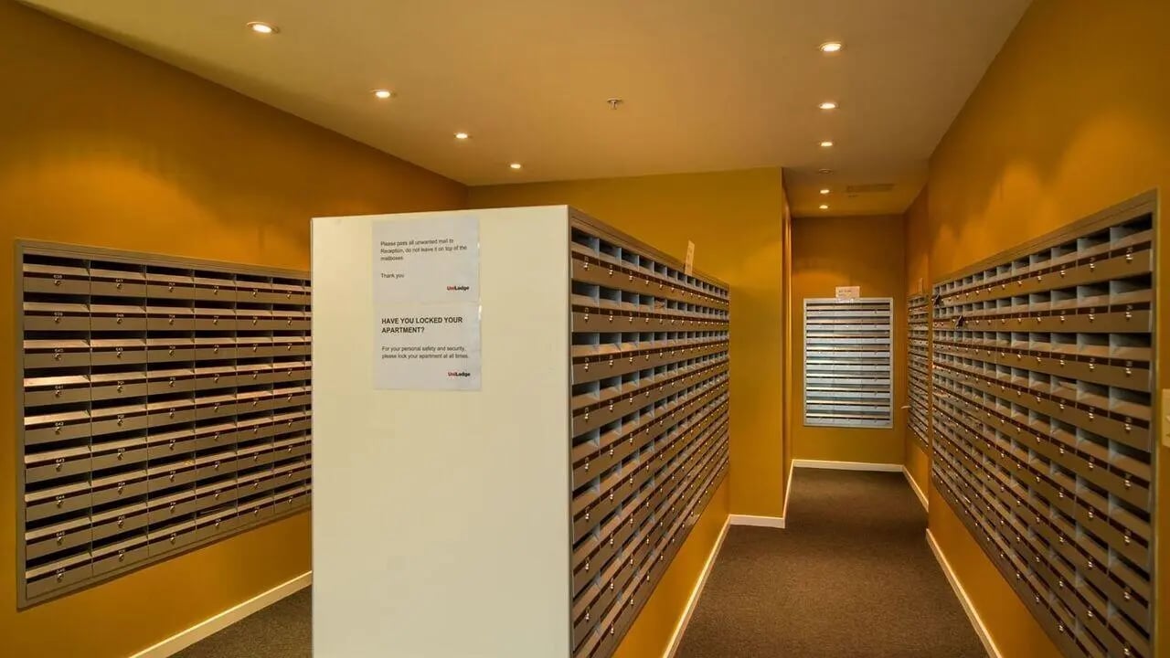 Mailboxes line hallway in student accommodation building hallway at Student Living - 800 Swanston in Melbourne Student Accommodation