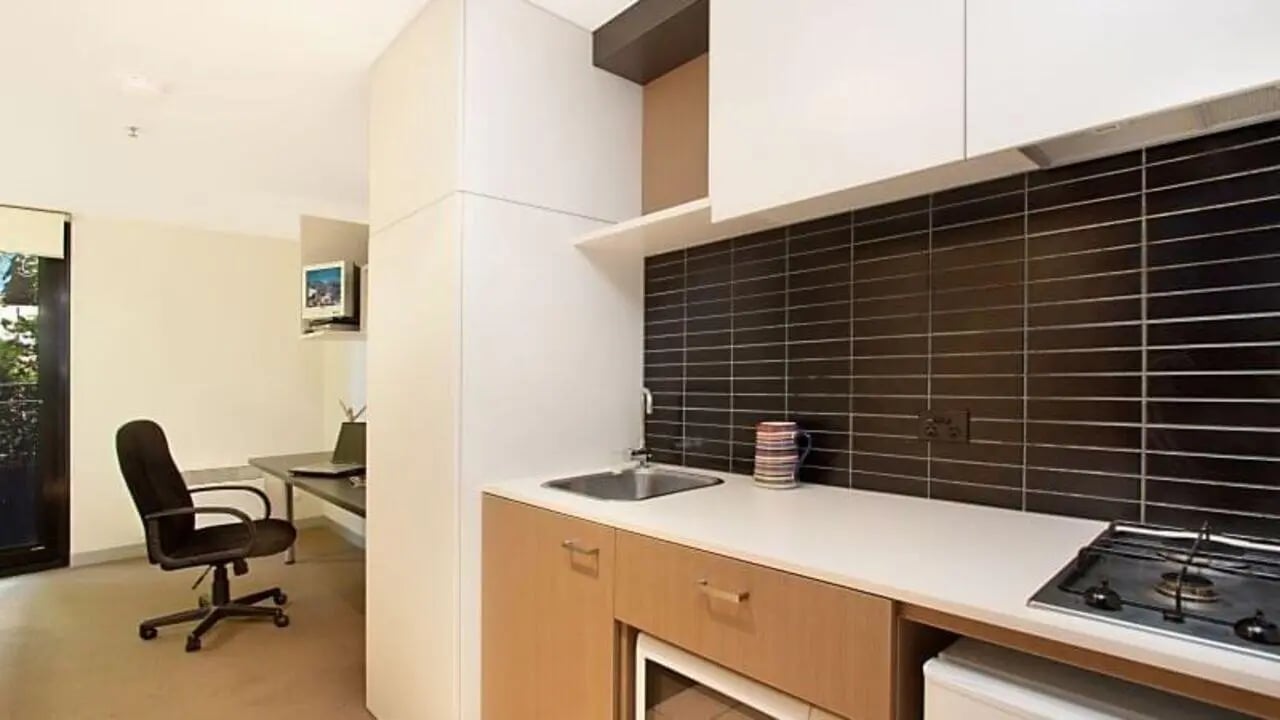Desk chair computer sink stovetop kitchen studio at Student Living on Riversdale in Melbourne Student Accommodation