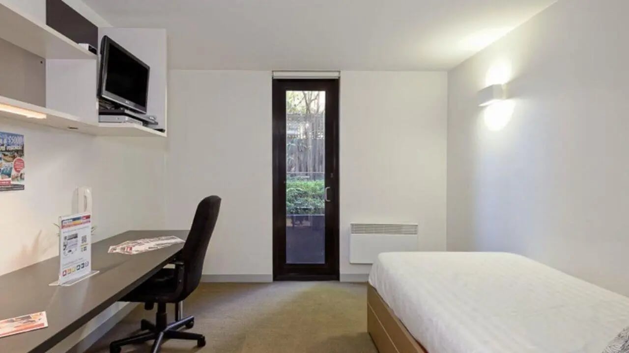 Bed desk TV and door bedroom at Student Living on Riversdale in Melbourne Student Accommodation