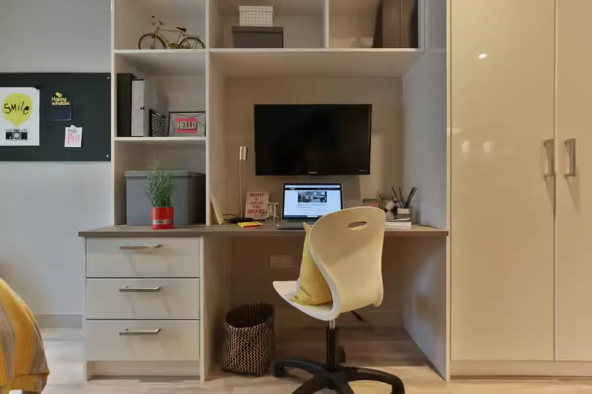 Desk with laptop chair television storage and wardrobe study area at Willowbank in Glasgow Student Accommodation