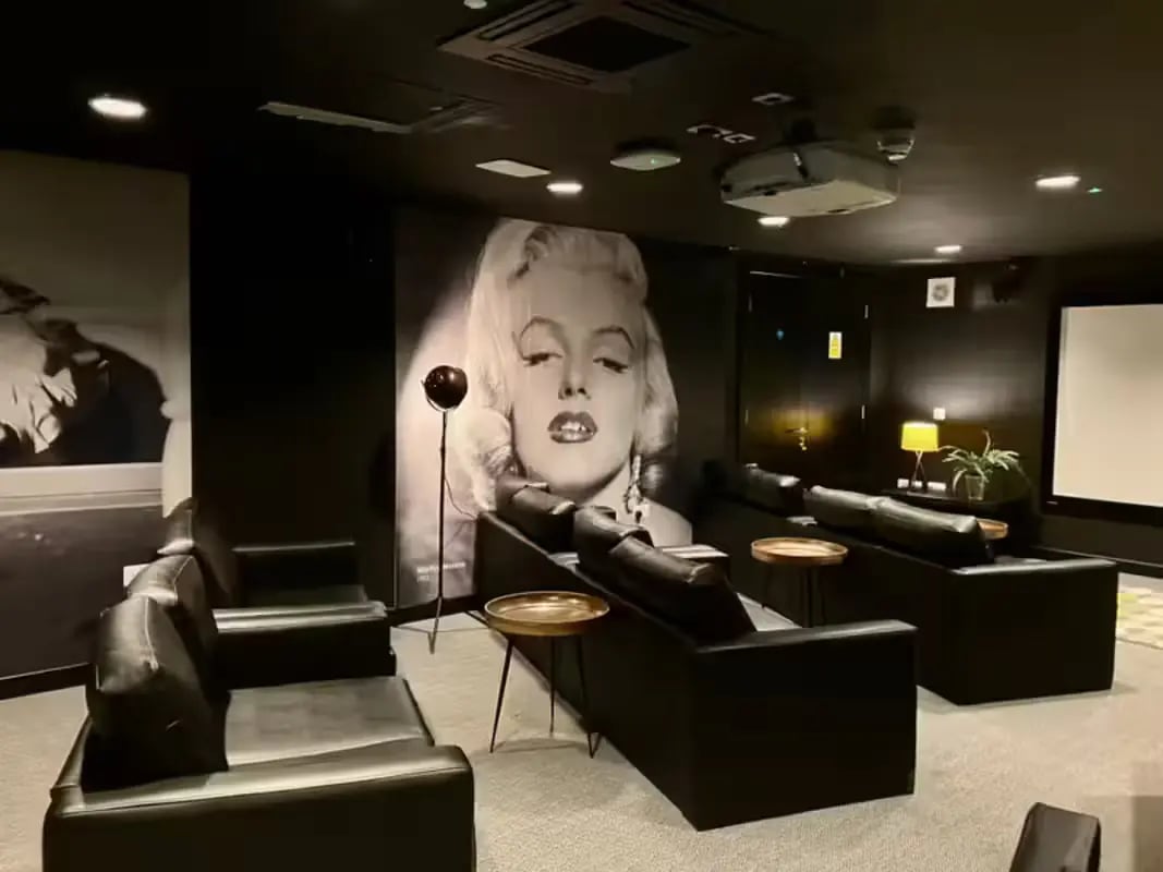Black couches projector Marilyn Monroe poster cinema room at Willowbank in Glasgow Student Accommodation