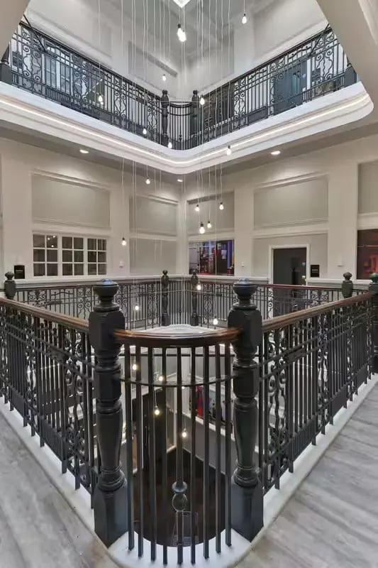 Ornate railings hanging lights atrium lobby at Willowbank in Glasgow Student Accommodation