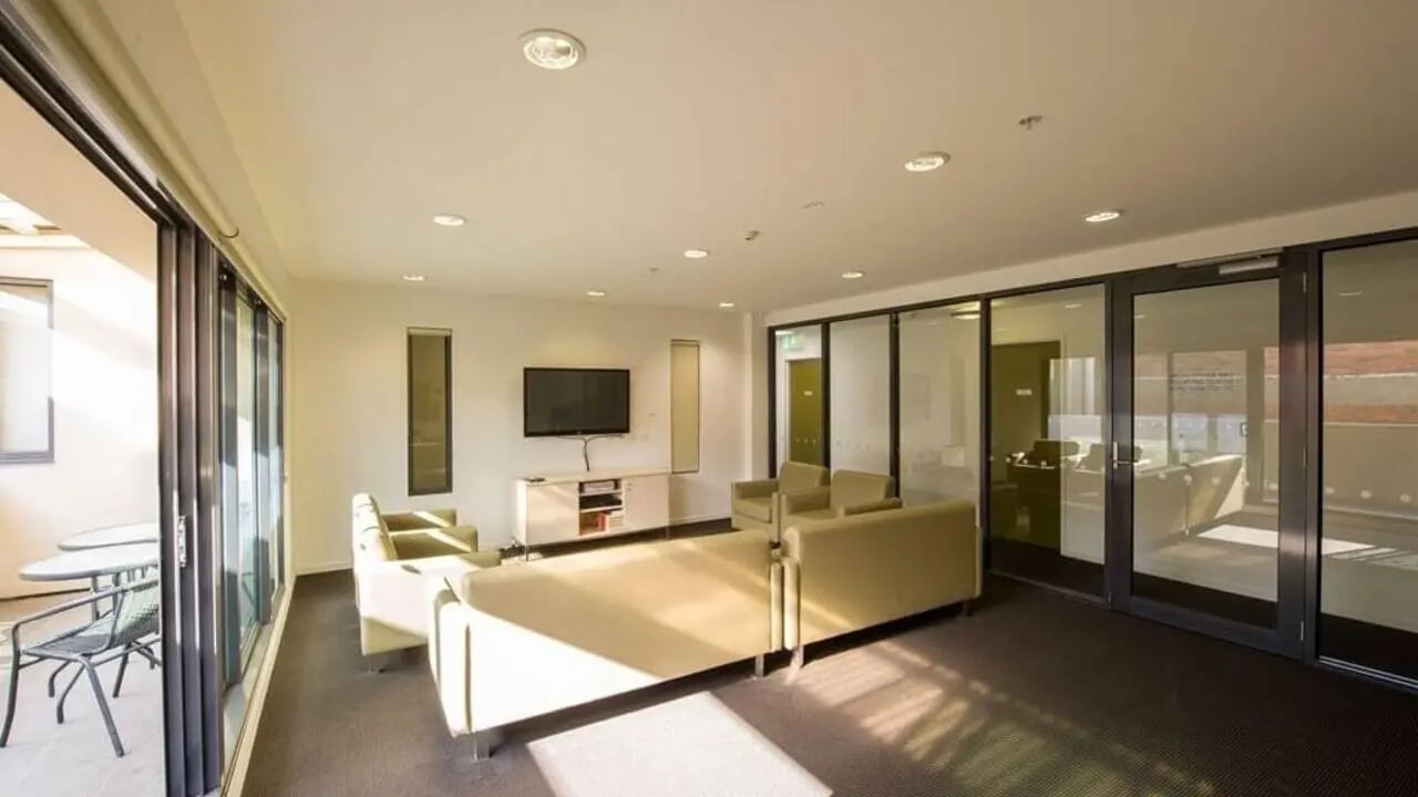 Sofa TV unit and balcony seating common area at Student Living on Cobden in Melbourne Student Accommodation