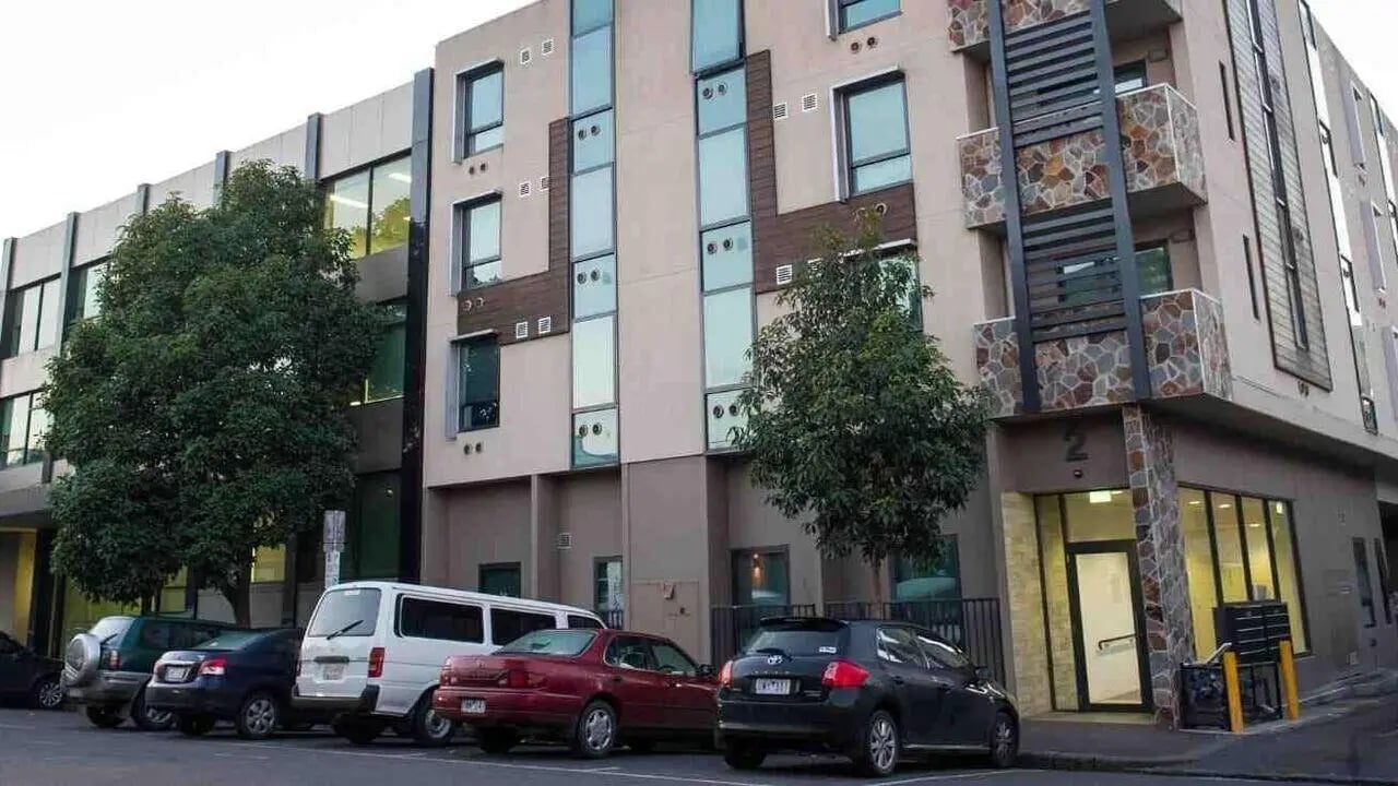 Modern building with cars and trees exterior at Student Living on Cobden in Melbourne Student Accommodation