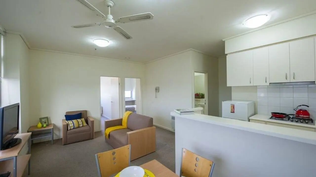 Living area with kitchen and seating area at Student Living - 550 Lygon in Melbourne Student Accommodation