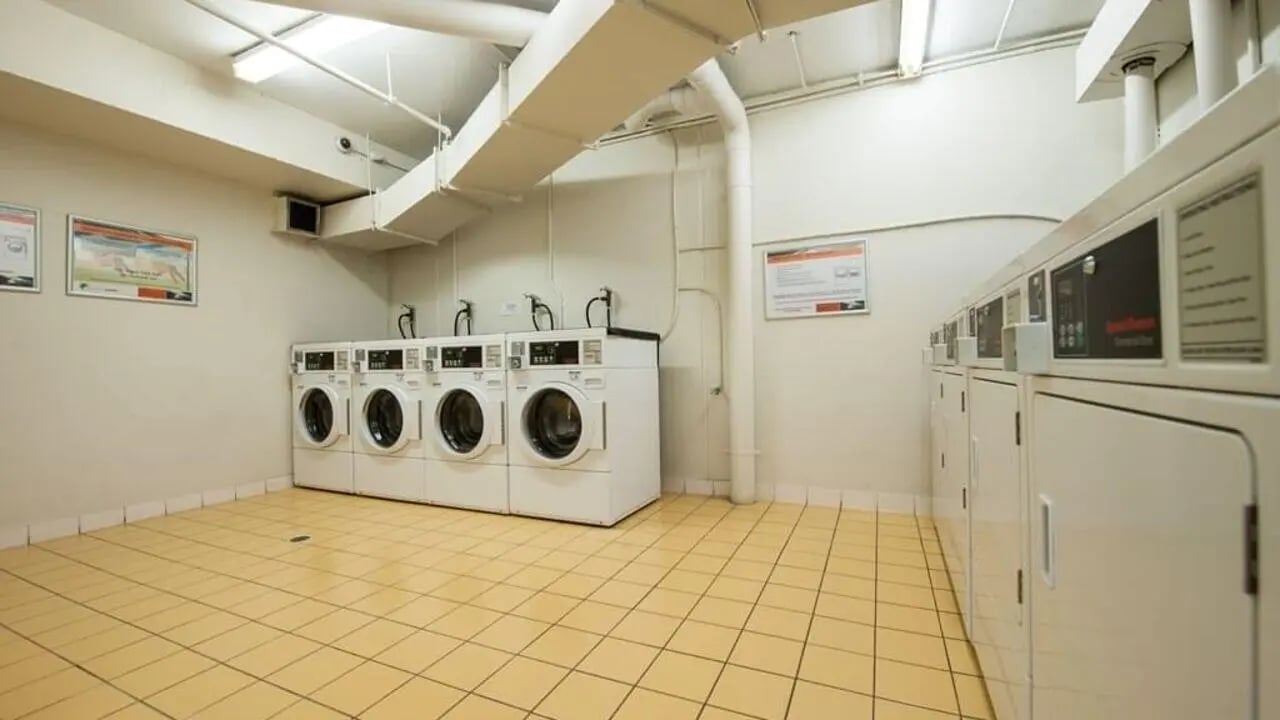 Row of washers and dryers laundry room at Student Living - 550 Lygon in Melbourne Student Accommodation