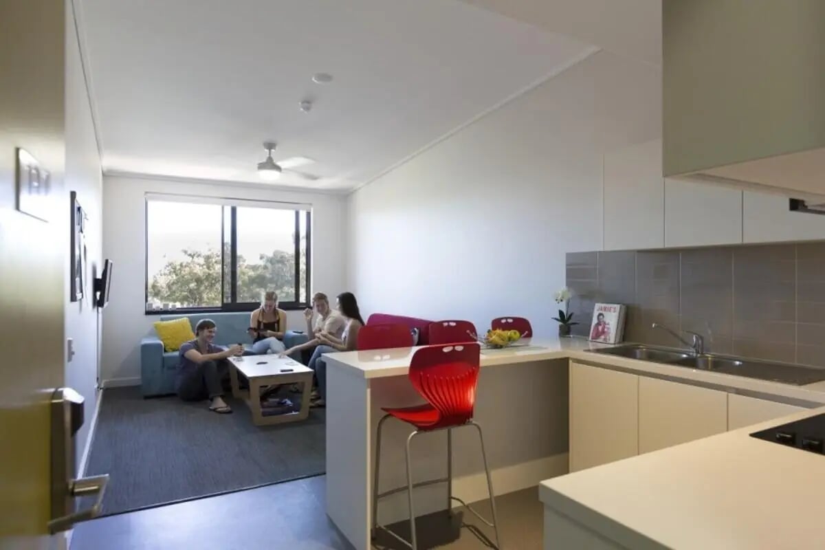 Students relaxing by window in living kitchen area at ECU Village Joondalup in Perth Student Accommodation