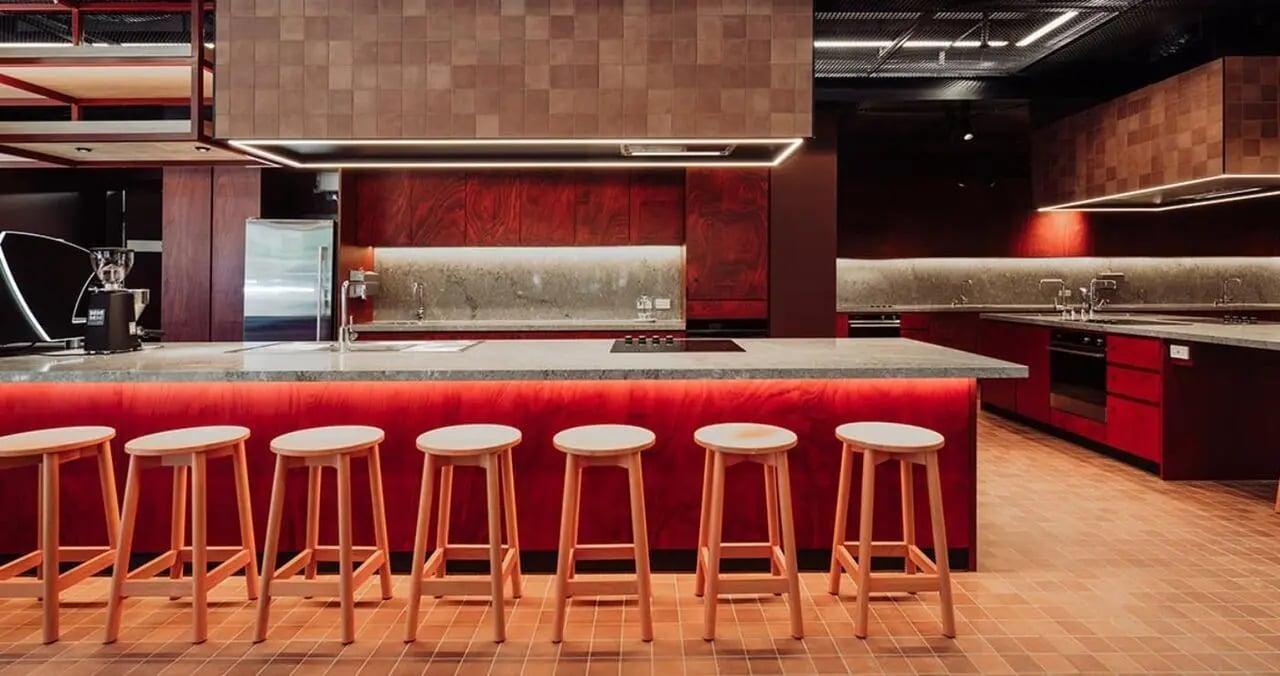 Red kitchen island with stools kitchen at Iglu Flagstaff Gardens in Melbourne Student Accommodation