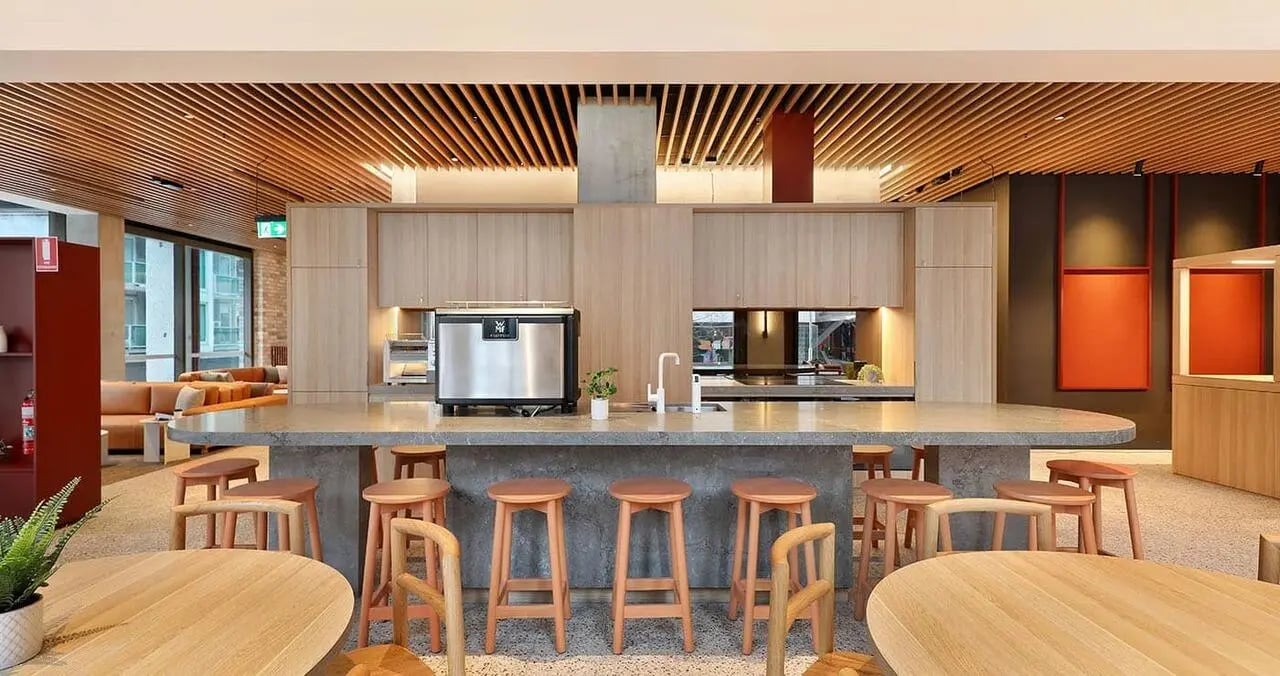 Modern kitchen island with stools and appliances communal kitchen at Iglu Melbourne Central in Melbourne Student Accommodation