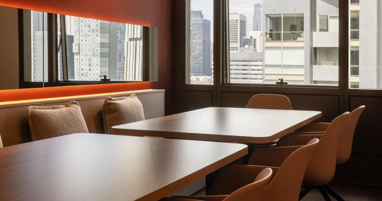Two tables chairs and city view dining area at Iglu Melbourne Central in Melbourne Student Accommodation