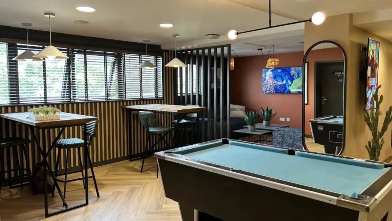 Pool table high tables plants living area at Northfield in Exeter Student Accommodation