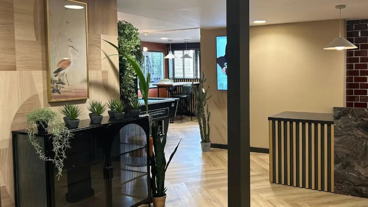 Black cabinet plants artwork and pool table common area at Northfield in Exeter Student Accommodation