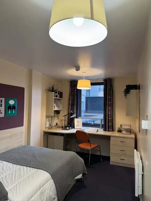 Bed desk chair and storage unit bedroom at The Plaza in Leeds Student Accommodation