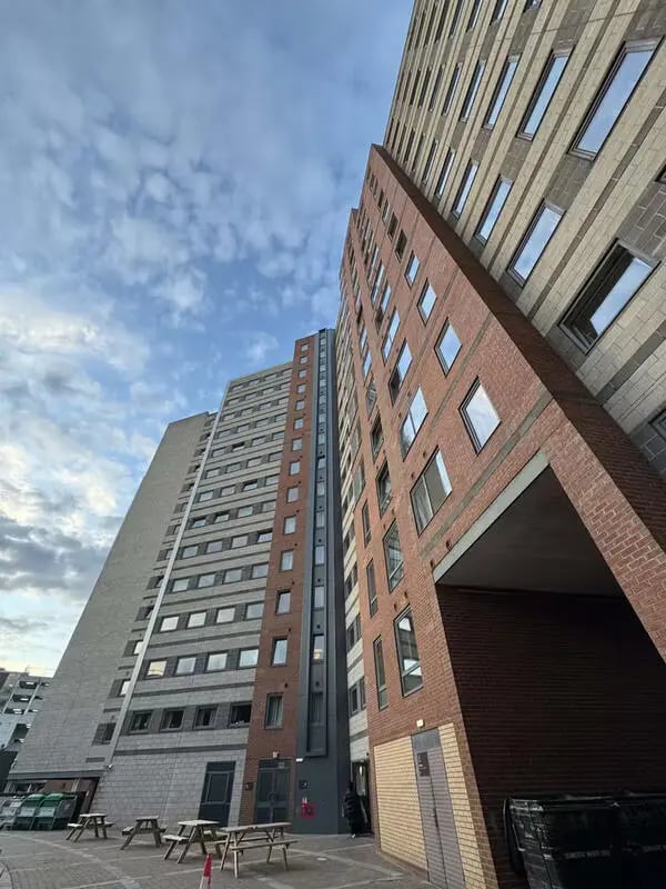 Tall apartment buildings with picnic tables exterior at The Plaza in Leeds Student Accommodation