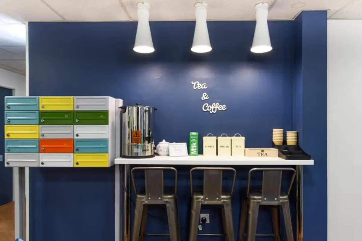 Colorful lockers hot water dispenser and coffee station kitchen at Apollo Court in Liverpool Student Accommodation