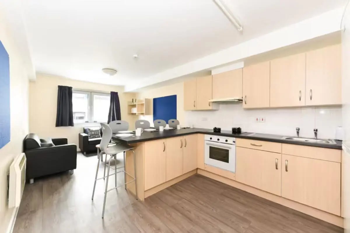 Kitchen dining area with sofa and chairs kitchen at Apollo Court in Liverpool Student Accommodation