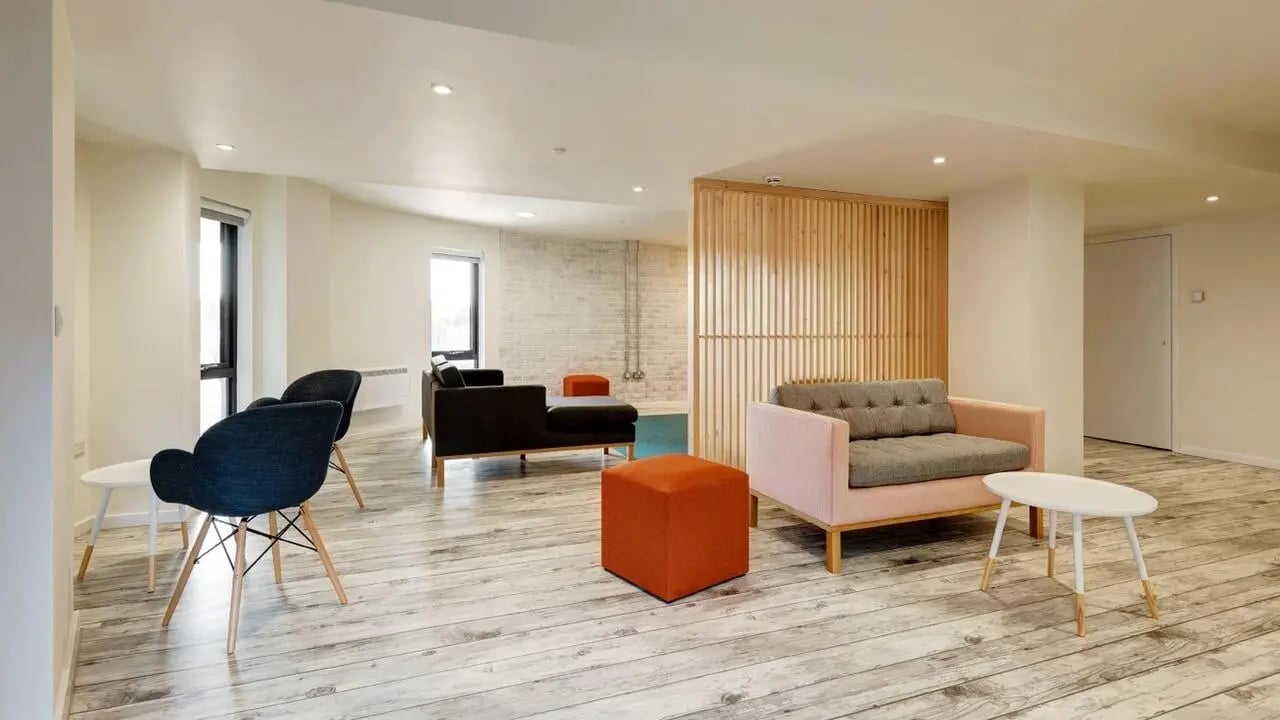 Sofa chairs and tables in communal living room at Collegiate Merlin Heights in Leicester Student Accommodation