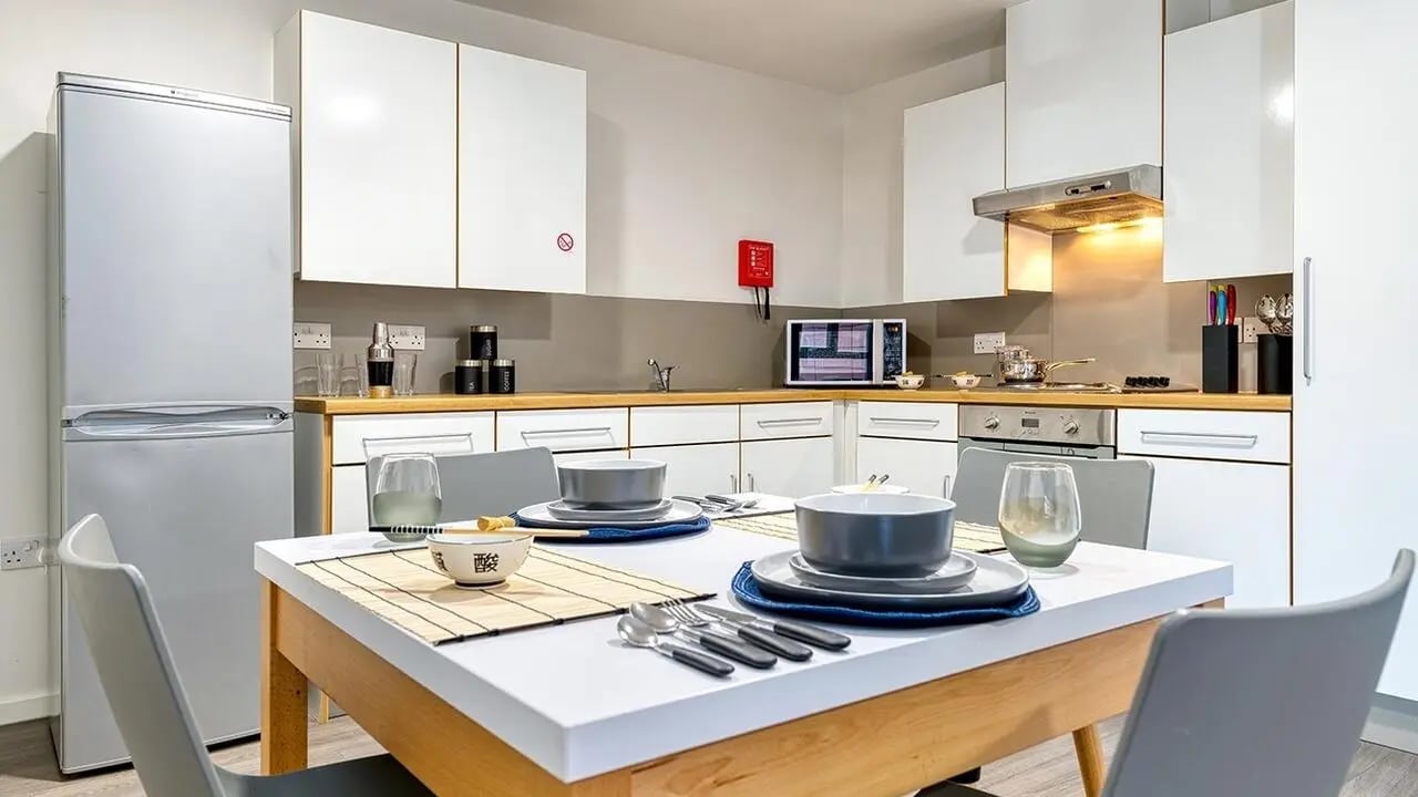 Modern kitchen with dining table and chairs kitchen at Collegiate Merlin Heights in Leicester Student Accommodation