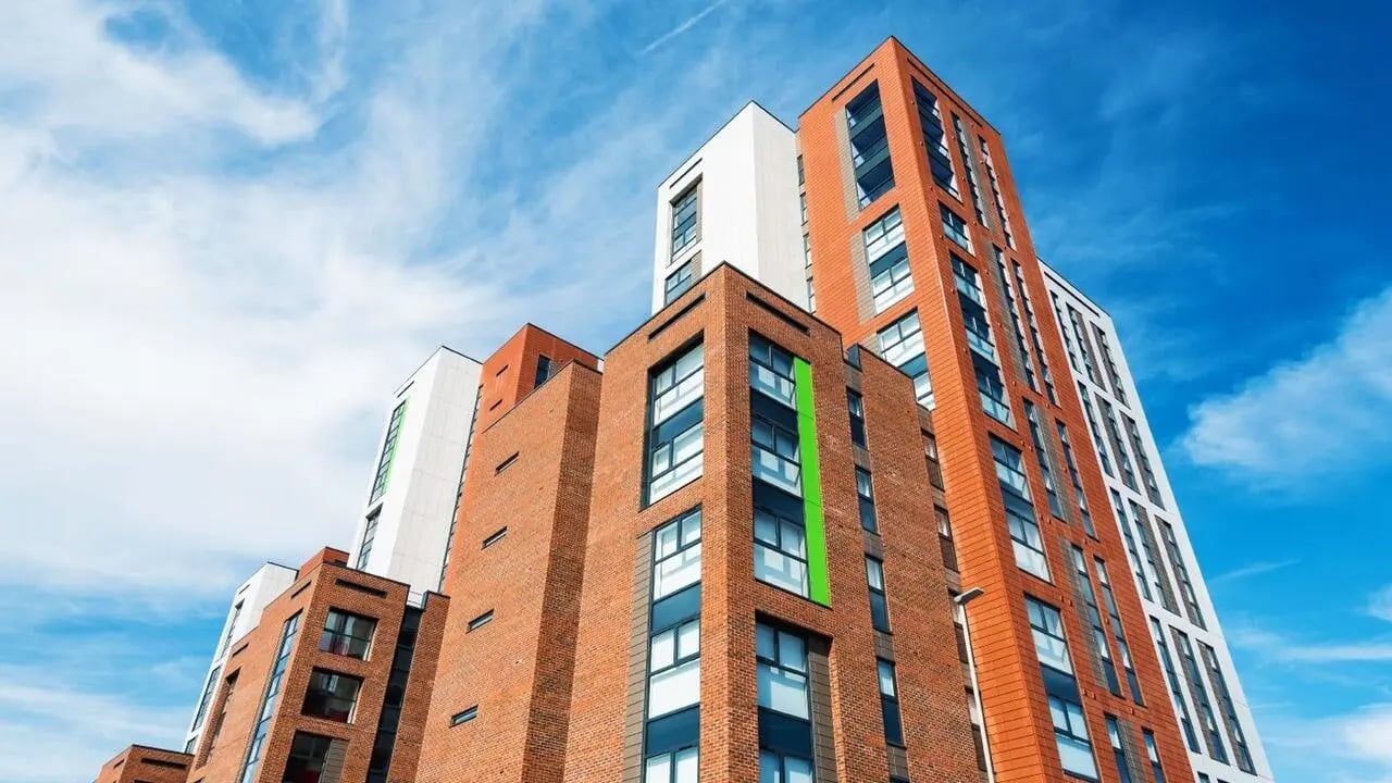 Modern brick buildings with white and orange panels exterior at Collegiate Merlin Heights in Leicester Student Accommodation
