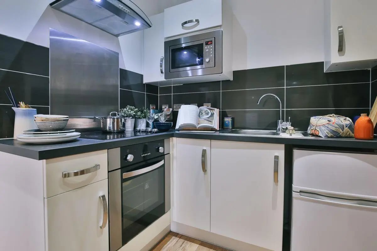 Modern compact kitchen with microwave oven and sink at 134 New Walk Leicester in Leicester Student Accommodation