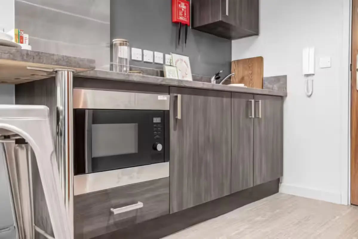 Microwave and cabinets in student kitchen kitchen at Windsor House in Cardiff Student Accommodation