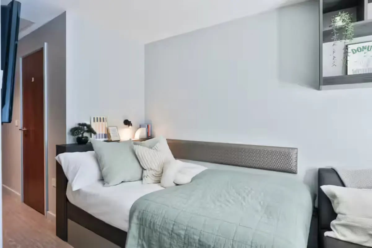 Bed pillows blankets and a shelf Bedroom at Windsor House in Cardiff Student Accommodation