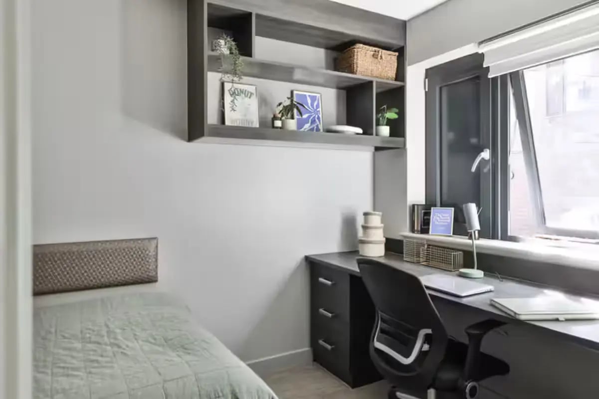 Bed desk shelving with decor and window bedroom at Windsor House in Cardiff Student Accommodation