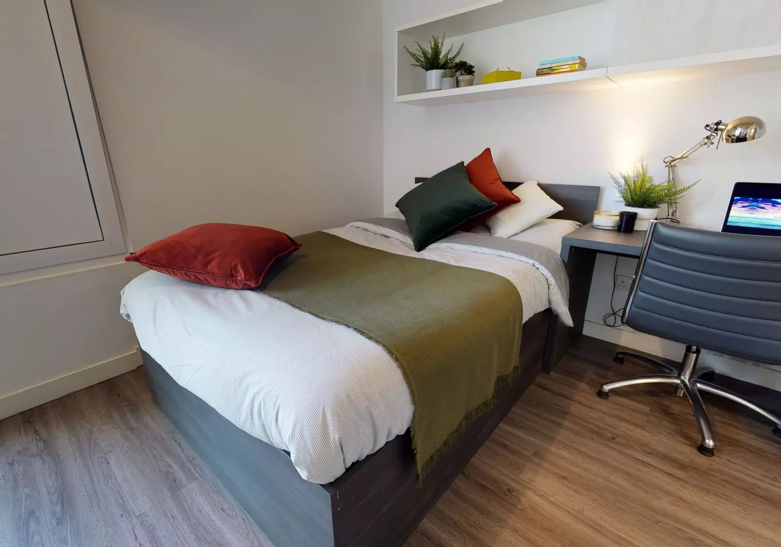 Bed desk chair and laptop bedroom at iQ Aldgate in London Student Accommodation