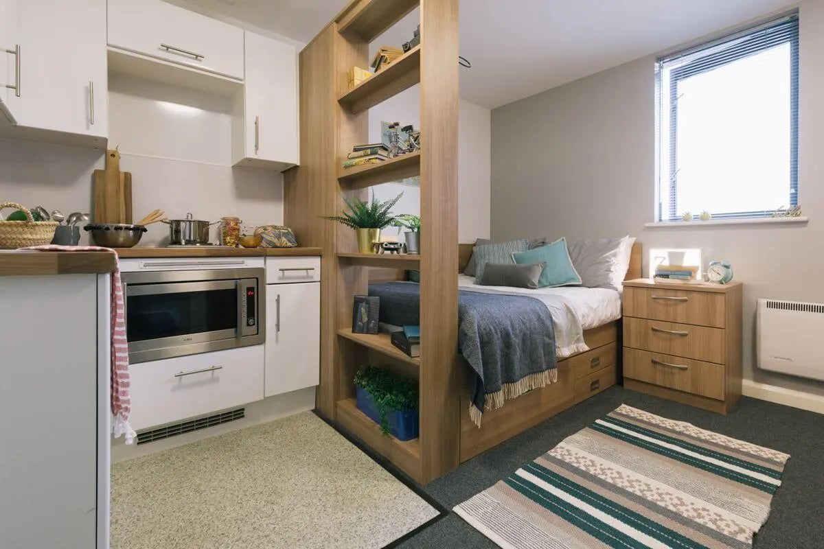 Kitchenette bed shelf and nightstand studio apartment at Applegate Place in Leicester Student Accommodation