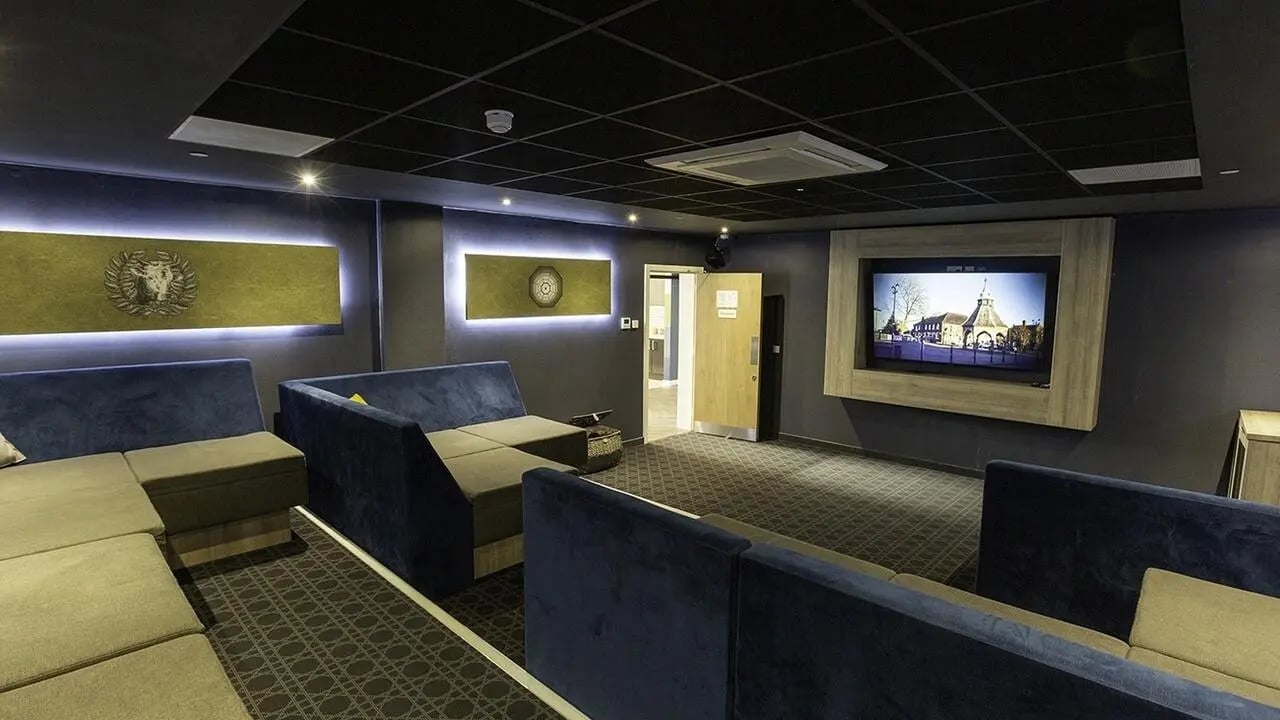 Sofa TV and artwork in lounge area at Collegiate Crown Place Norwich in Norwich Student Accommodation