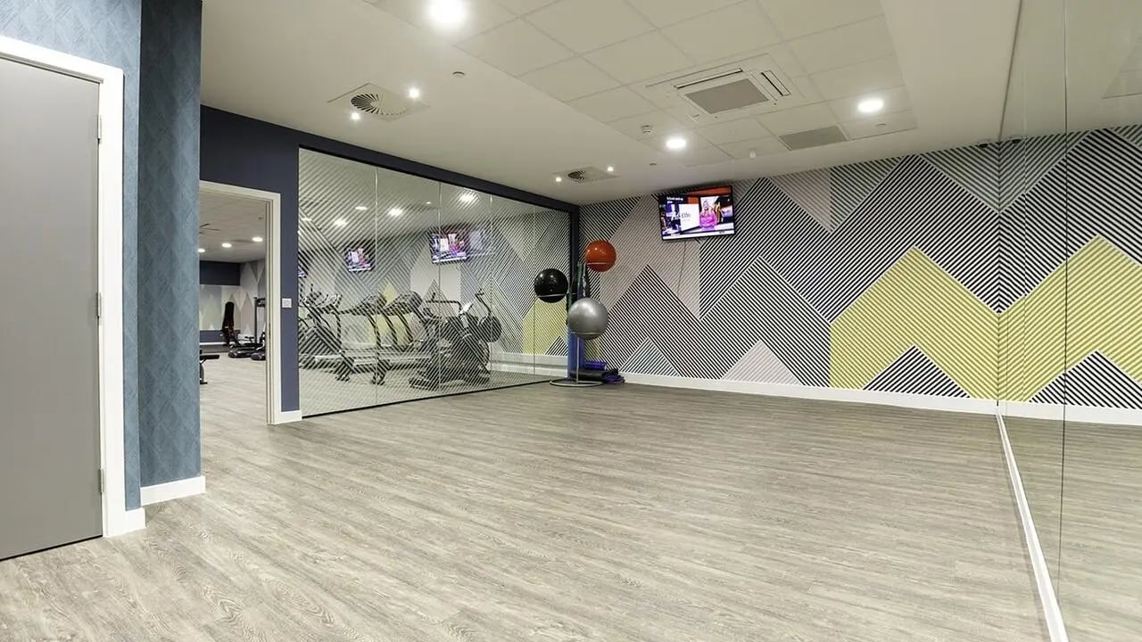 Gym equipment with exercise balls and TVs gym at Collegiate Crown Place Norwich in Norwich Student Accommodation