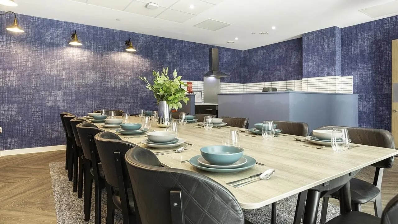 Large dining table with place settings common area at Collegiate Crown Place Norwich in Norwich Student Accommodation
