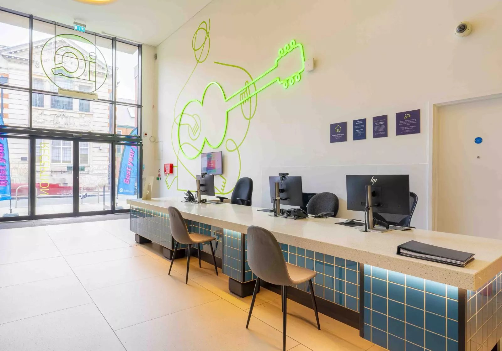 Reception desk with computers and chairs reception area at iQ Hammersmith in London Student Accommodation