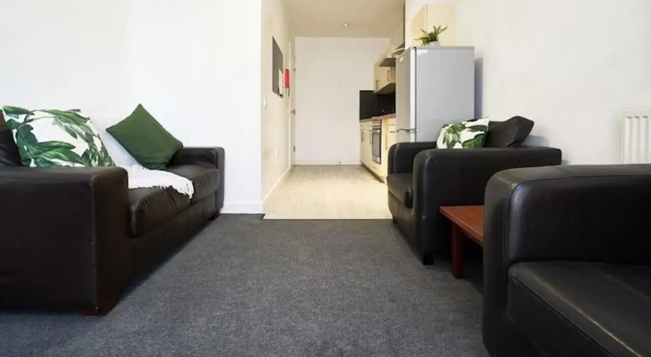Dark sofas with patterned pillows living room at Windsor Court in Liverpool Student Accommodation