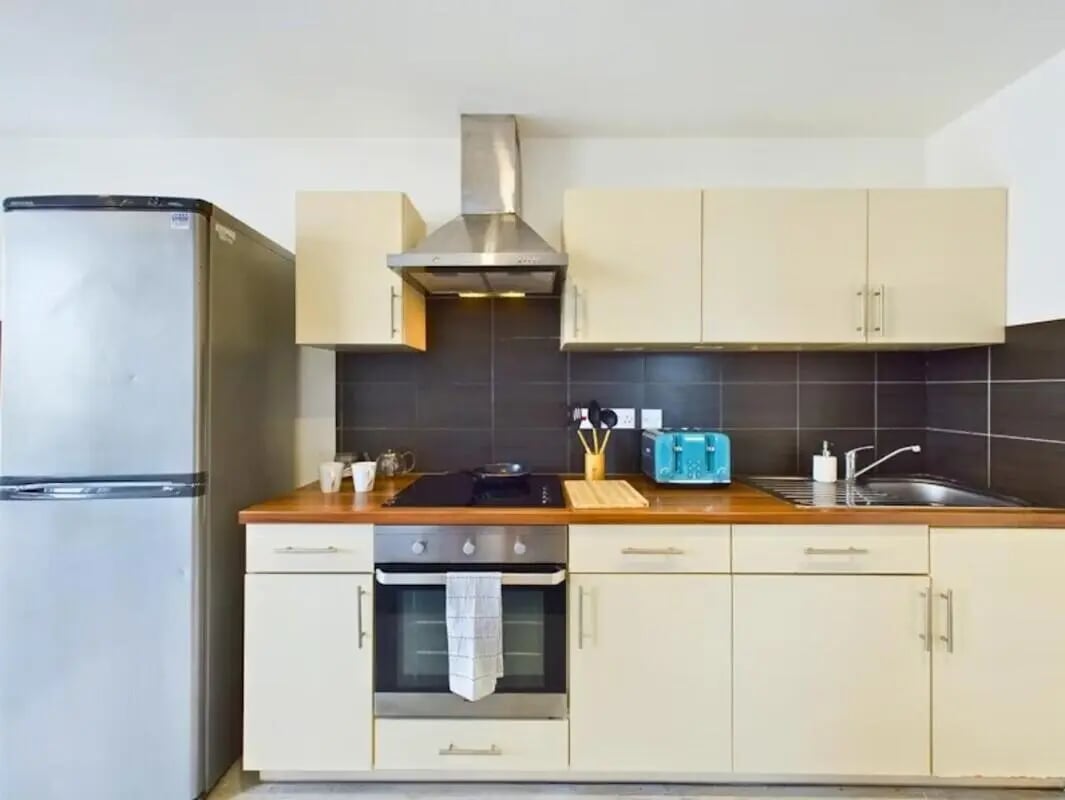 Silver refrigerator toaster oven and cabinets kitchen at Windsor Court in Liverpool Student Accommodation