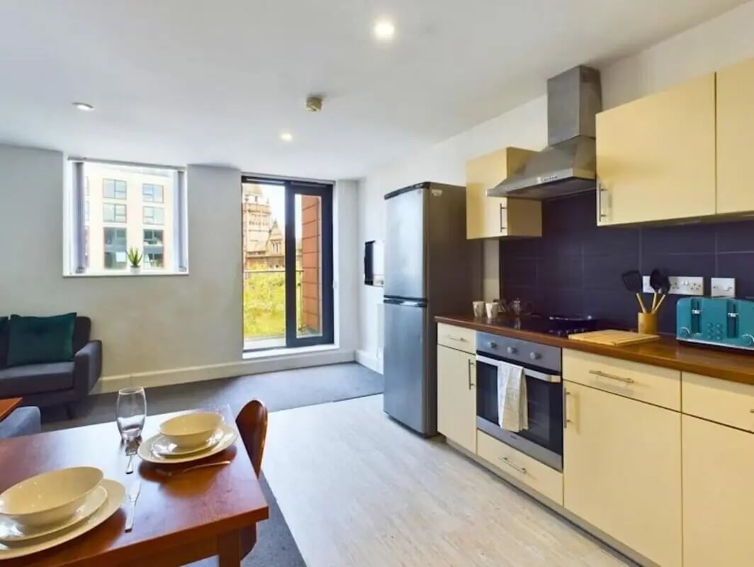 Kitchen area with sofa dining table and window at Windsor Court in Liverpool Student Accommodation