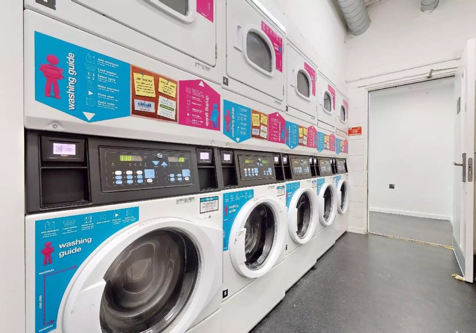 Row of washing machines laundry room at iQ Highbury in London Student Accommodation