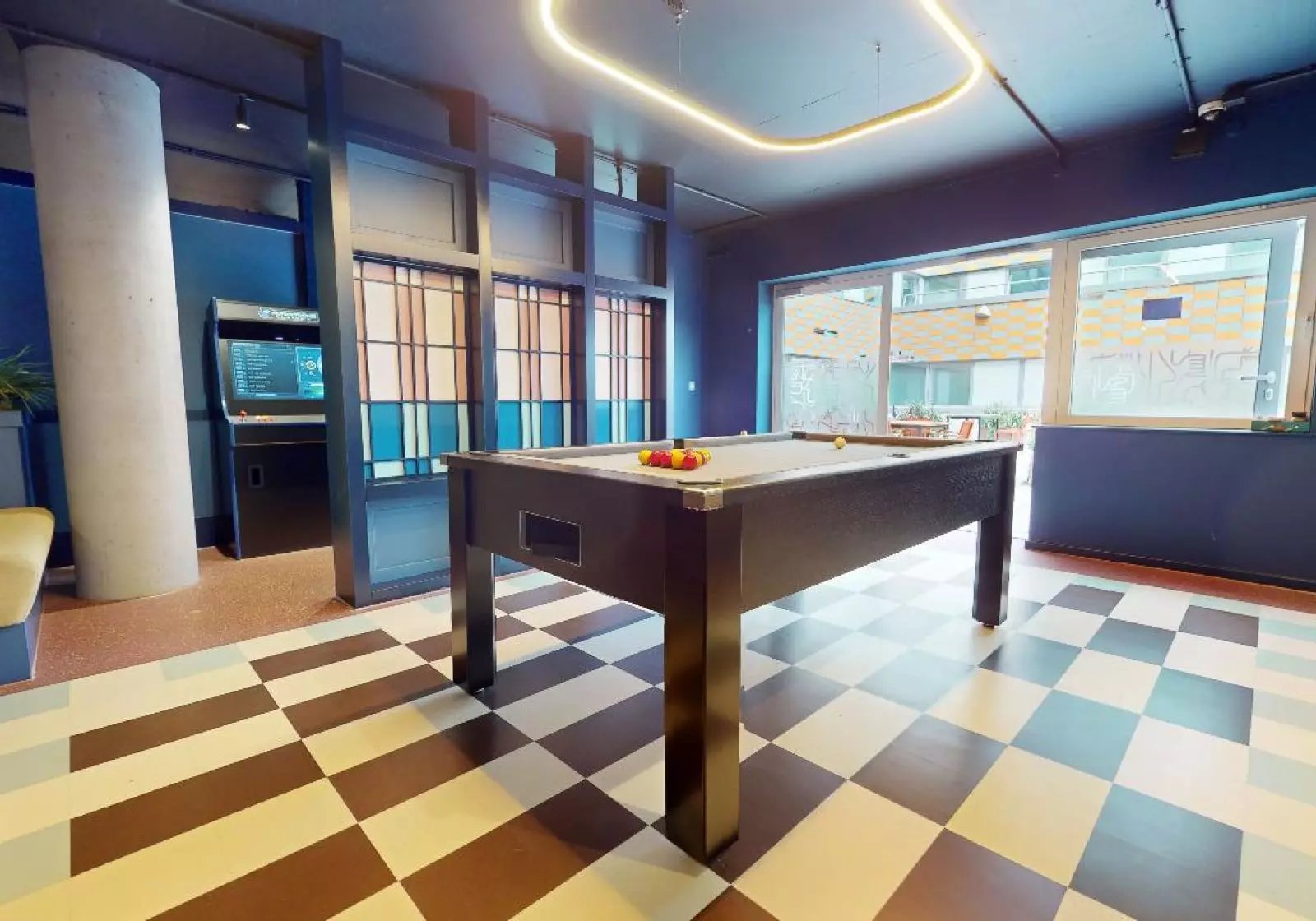 Pool table arcade game and checkered floor common area at iQ Highbury in London Student Accommodation