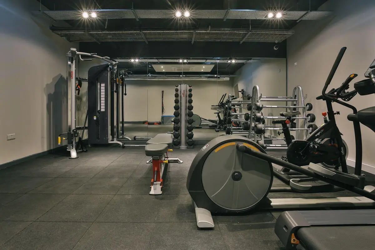 Gym equipment with weights and cardio machines gym at The Chapel in Manchester Student Accommodation