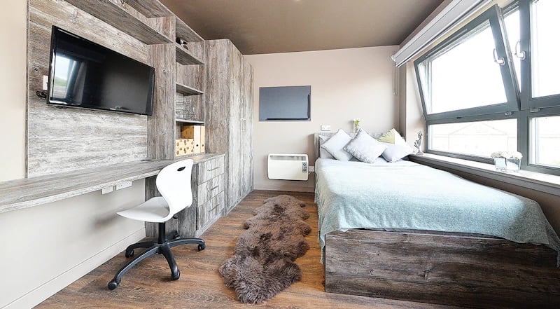 Bed desk chair TV and window bedroom at Marketgait Apartments in Dundee Student Accommodation