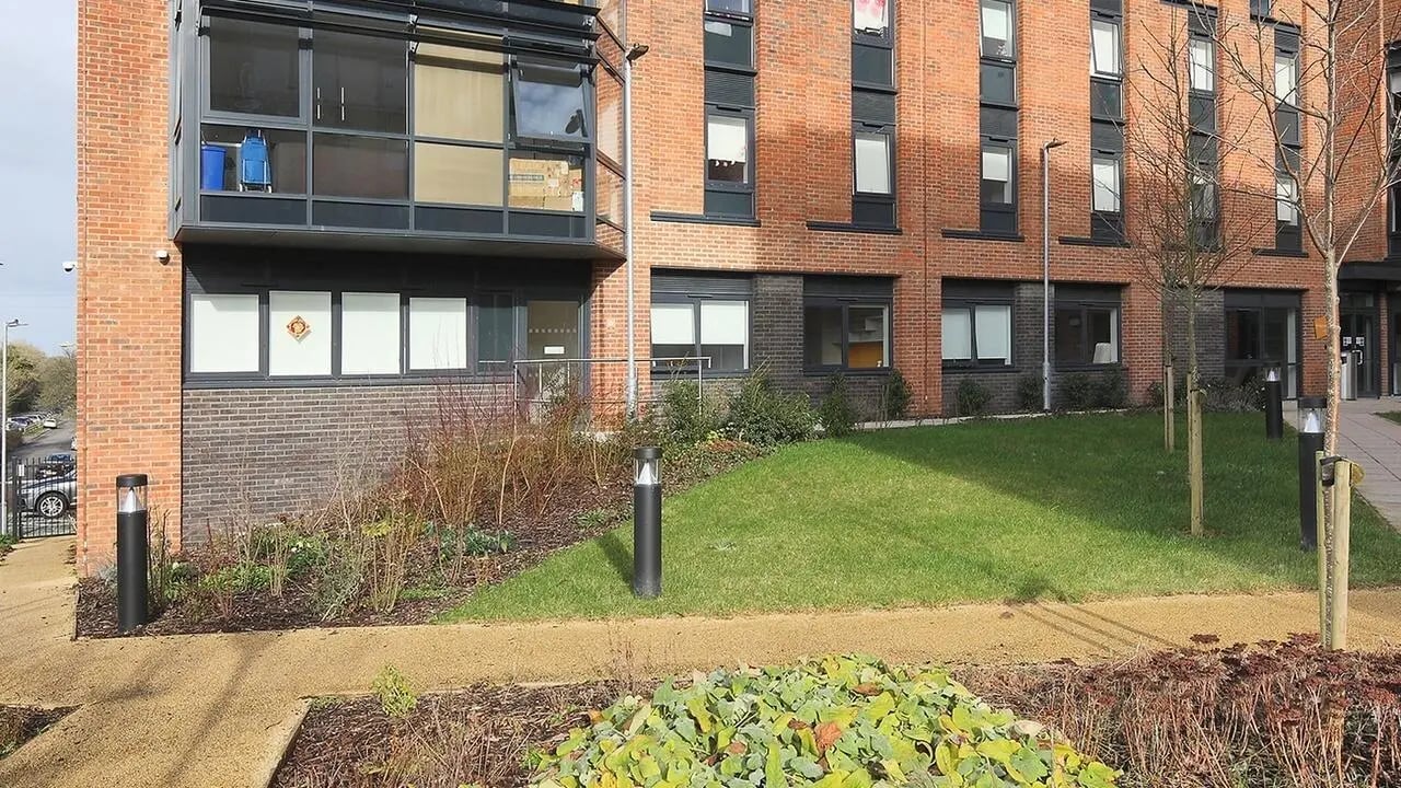 Brick building with lawn and pathway exterior at Collegiate Riverside Way Winchester in Winchester Student Accommodation